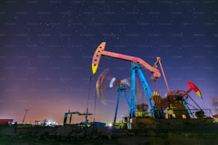 At night, oil pumps under the stars