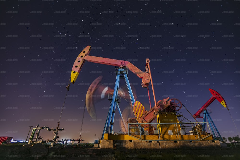 At night, oil pumps under the stars