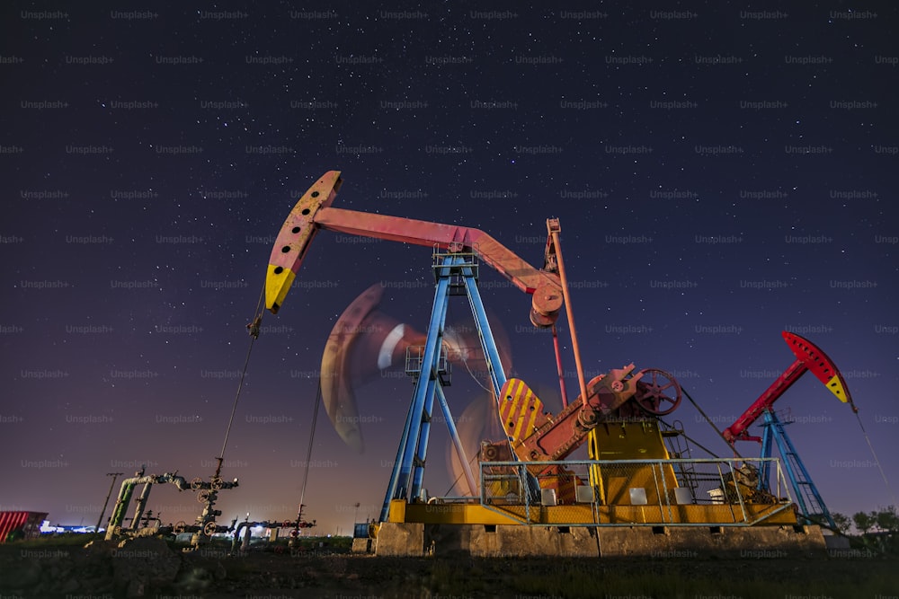 At night, oil pumps under the stars