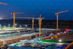 The building site is in the evening, Tower cranes build residential buildings