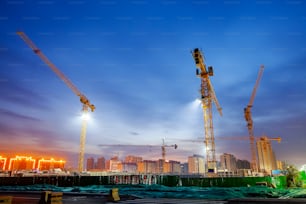 The building site is in the evening, Tower cranes build residential buildings