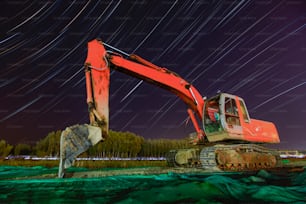 Excavator is under the stars, Digger and star tracks at night