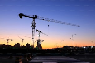 The building site is in the evening, Tower cranes build residential buildings