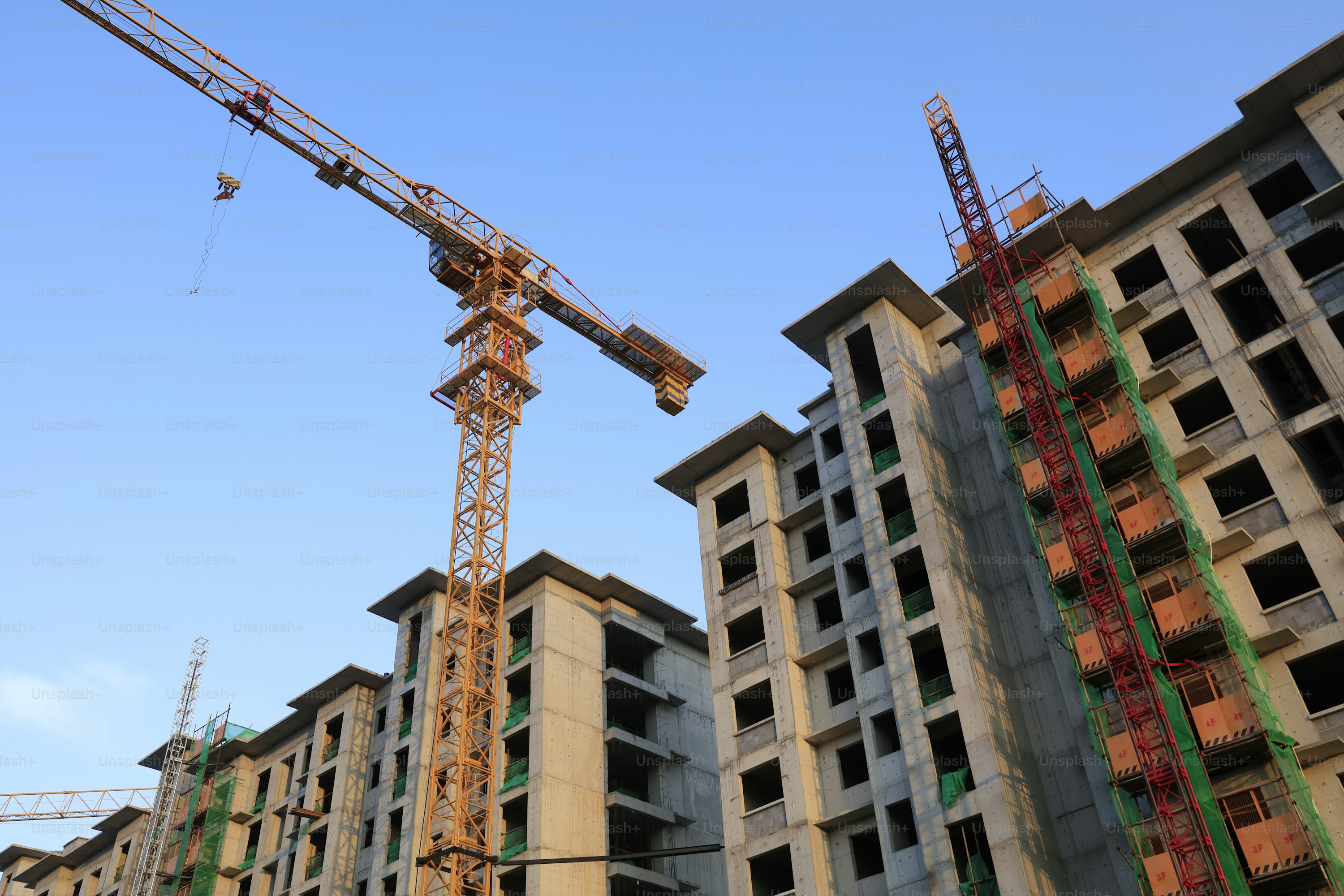Construction site with tower crane and residential buildings under construction modular