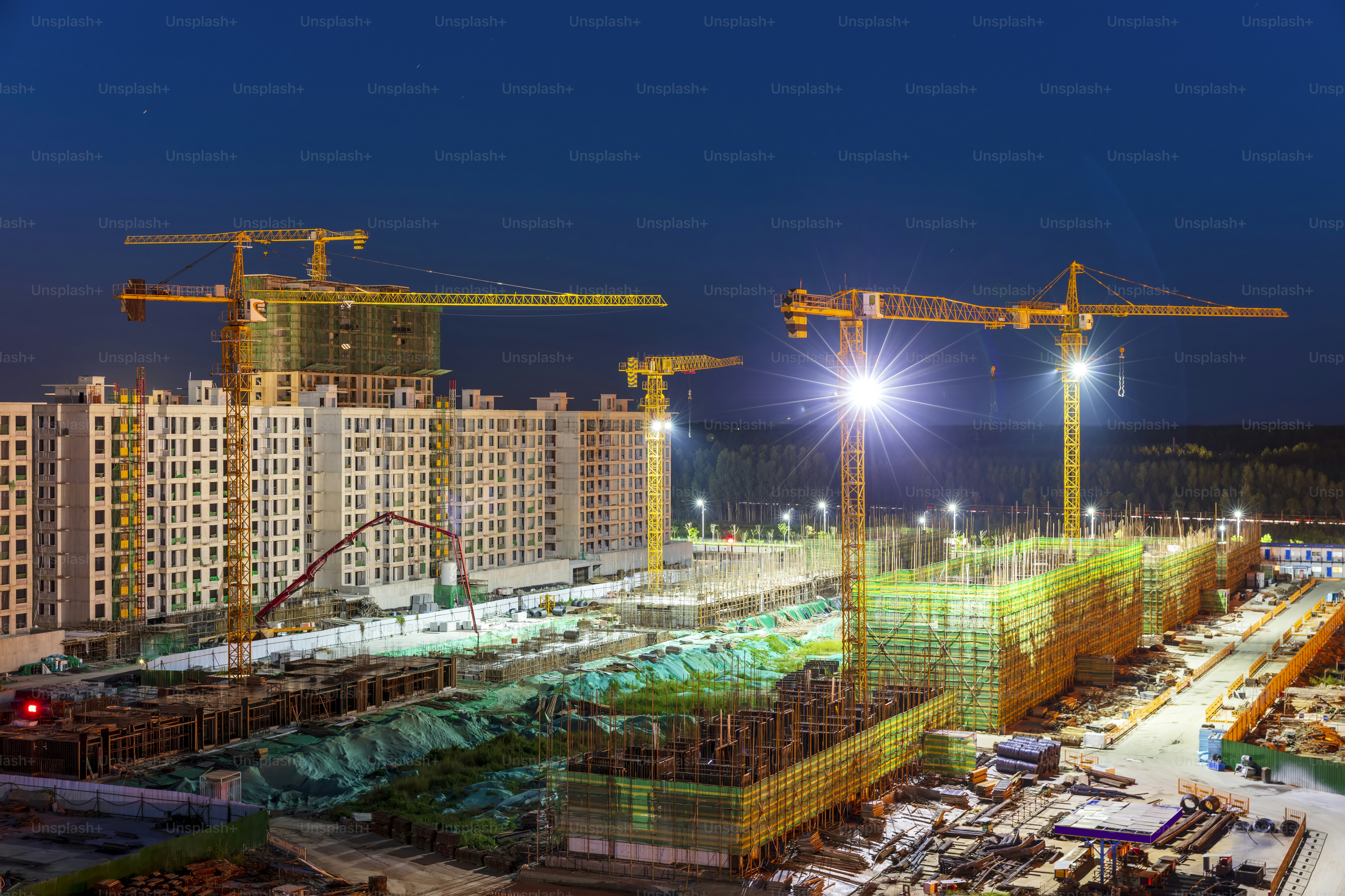 The building site is in the evening, Tower cranes build residential buildings