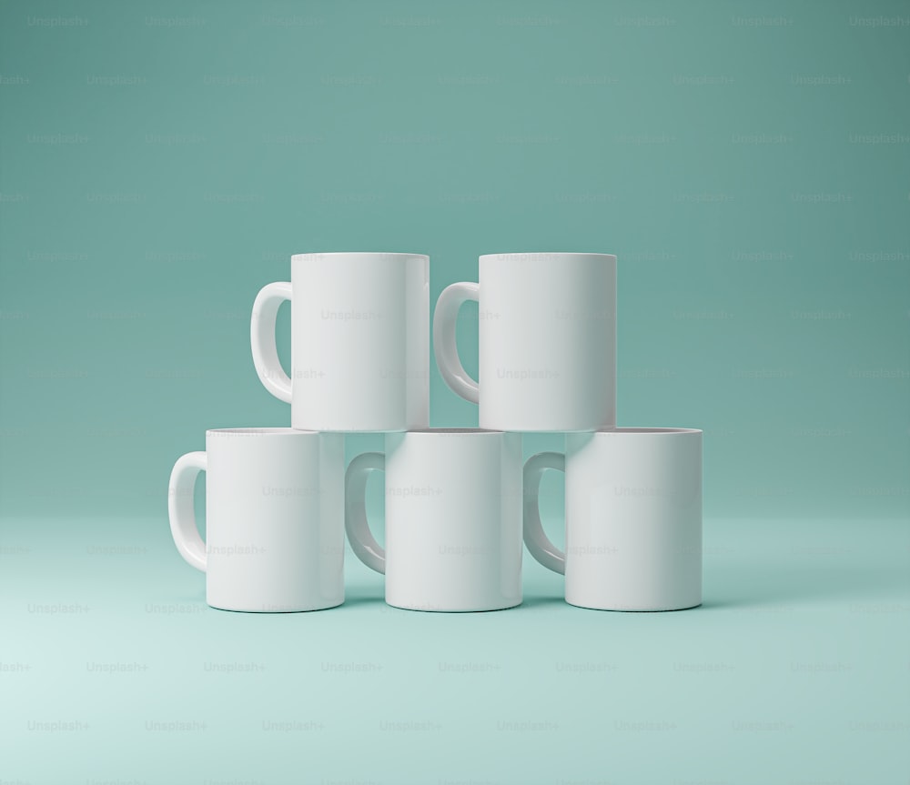 a group of white coffee mugs stacked on top of each other