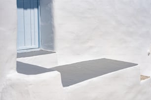 a white building with a blue door and window