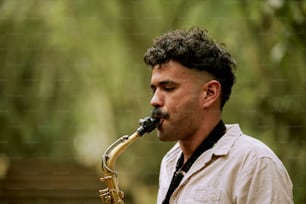 a man playing a saxophone in a forest