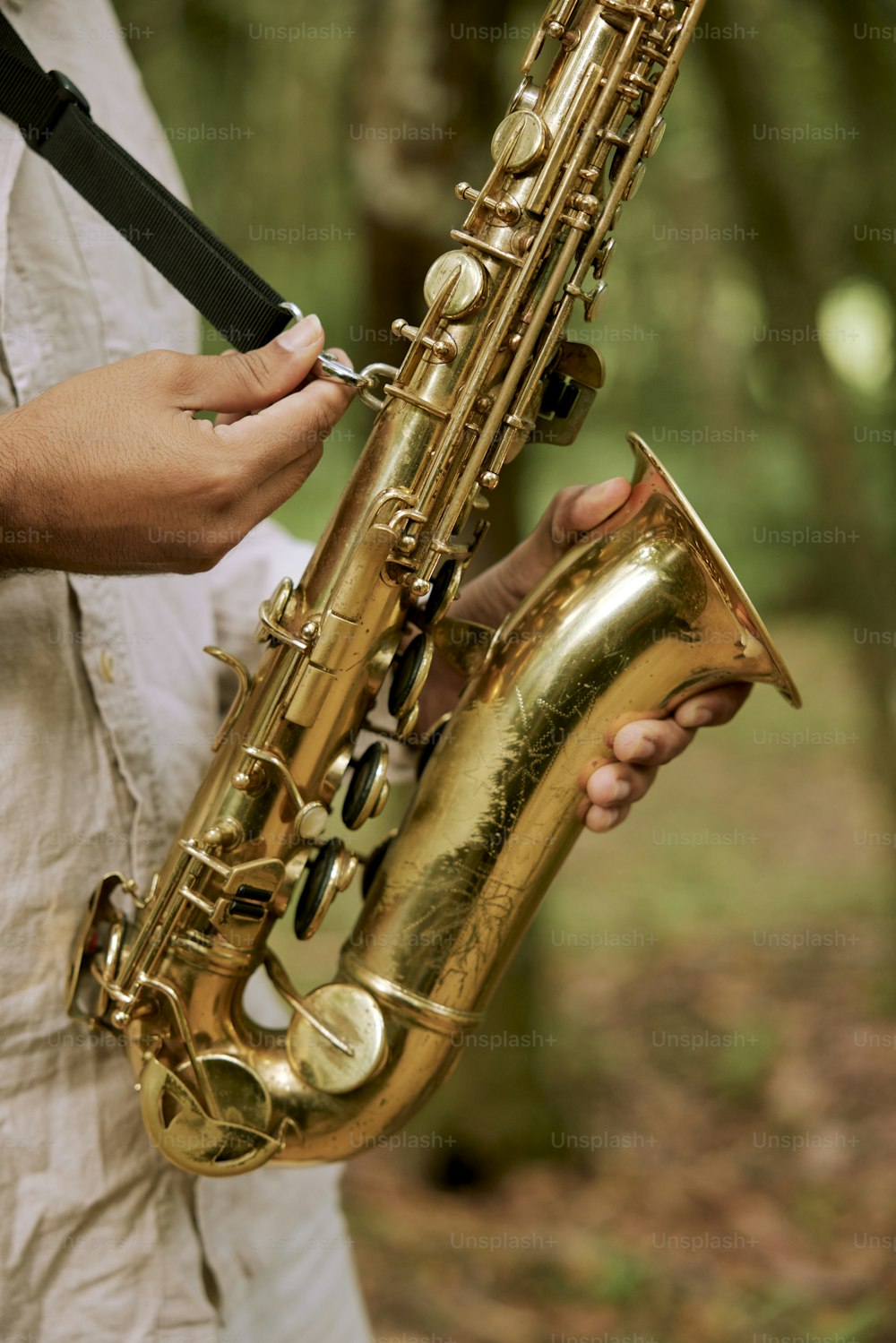 a person holding a saxophone in their hands