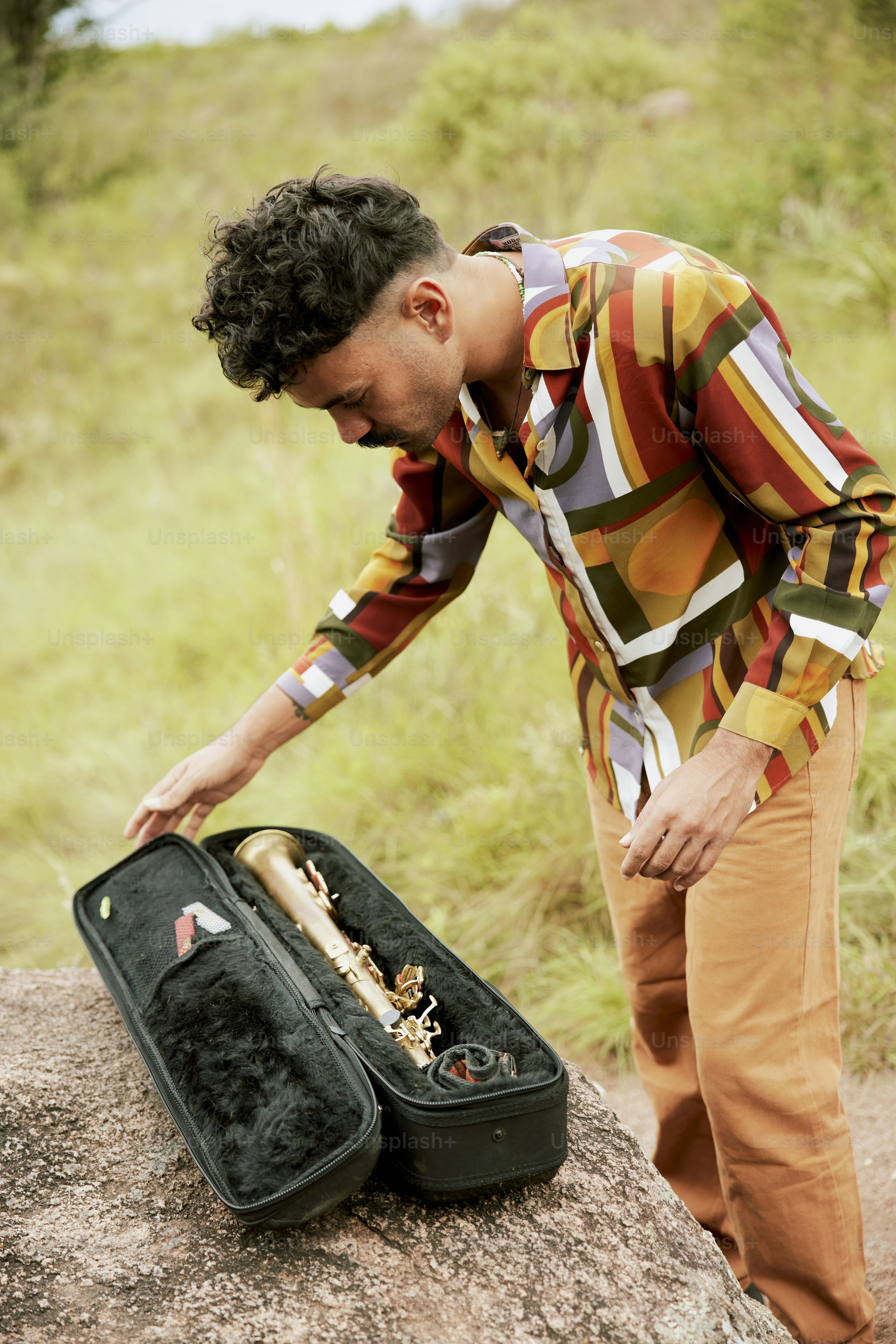 a man standing next to a piece of luggage