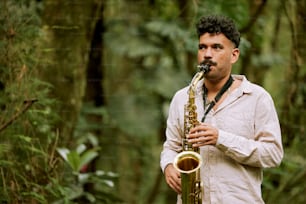 a man playing a saxophone in a forest