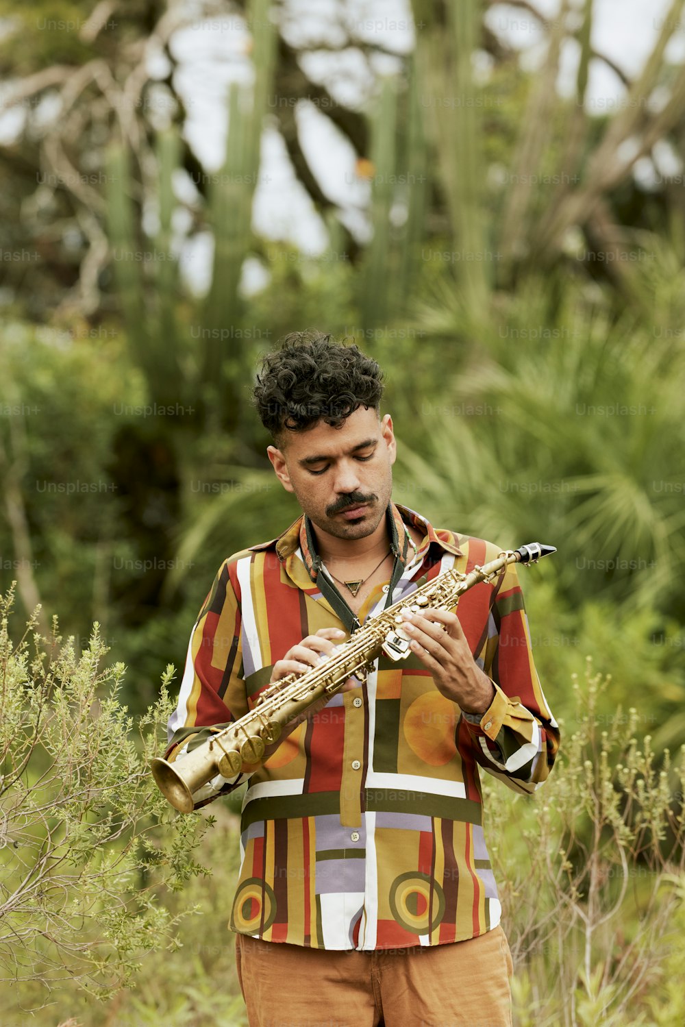 a man is playing a musical instrument in a field