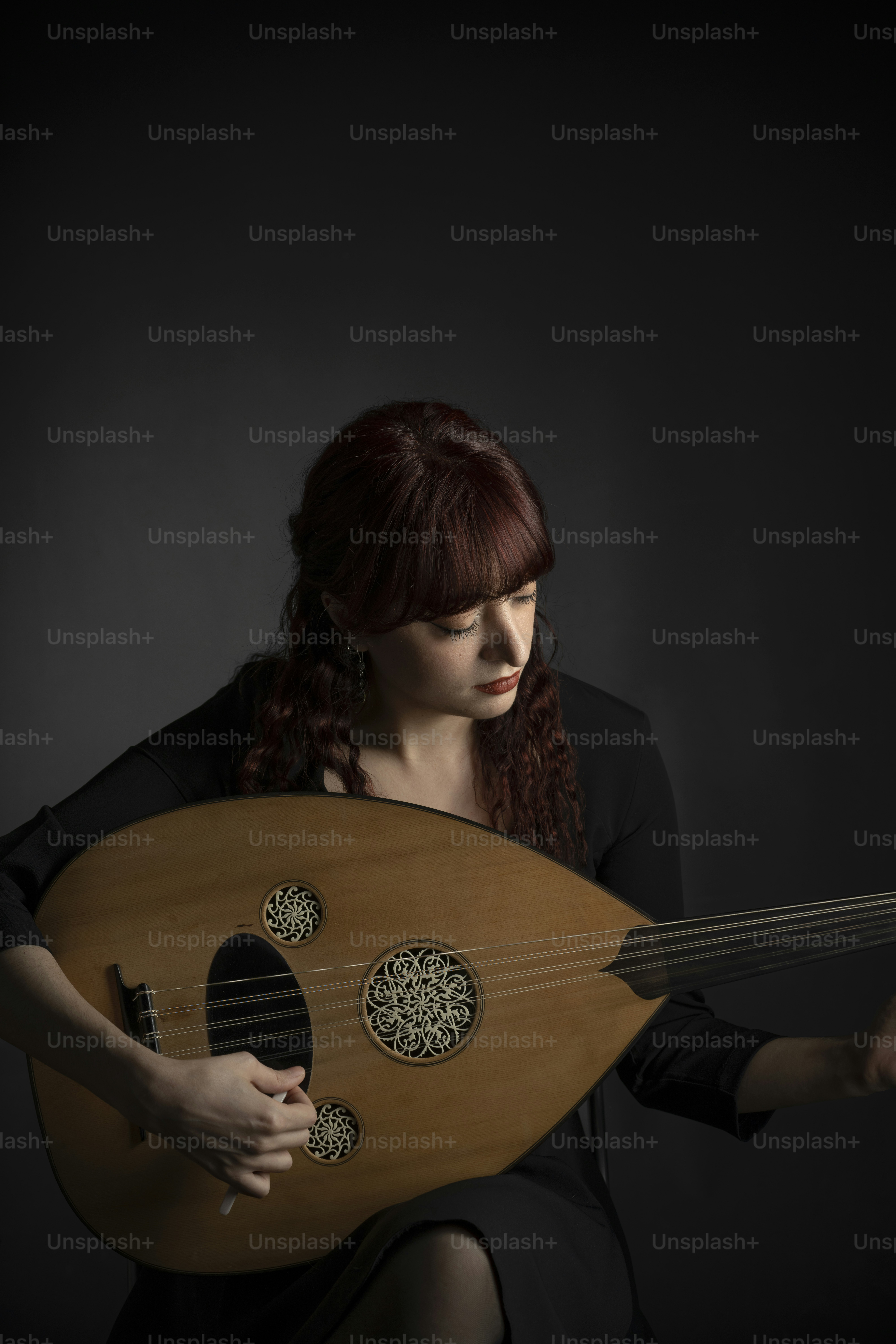 A close up of a person holding a musical instrument photo – Music Image ...