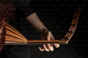 a close up of a person holding a musical instrument