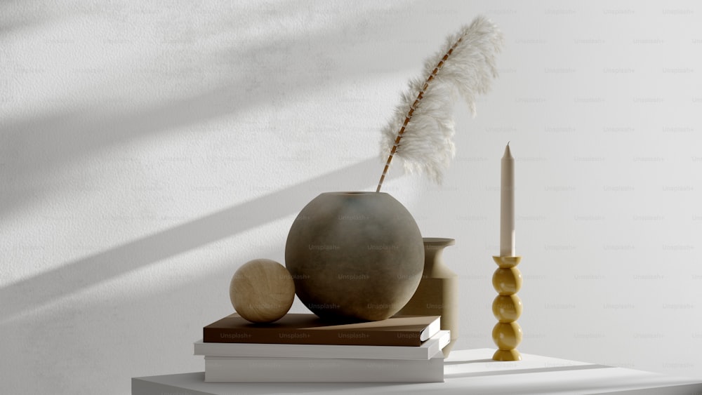 a vase with a feather on top of a stack of books