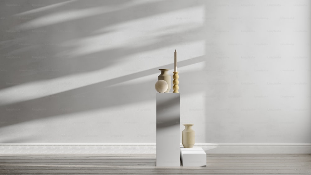 a couple of vases sitting on top of a white pedestal