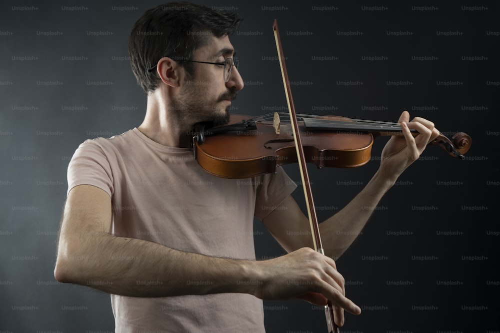 a man playing a violin on a black background