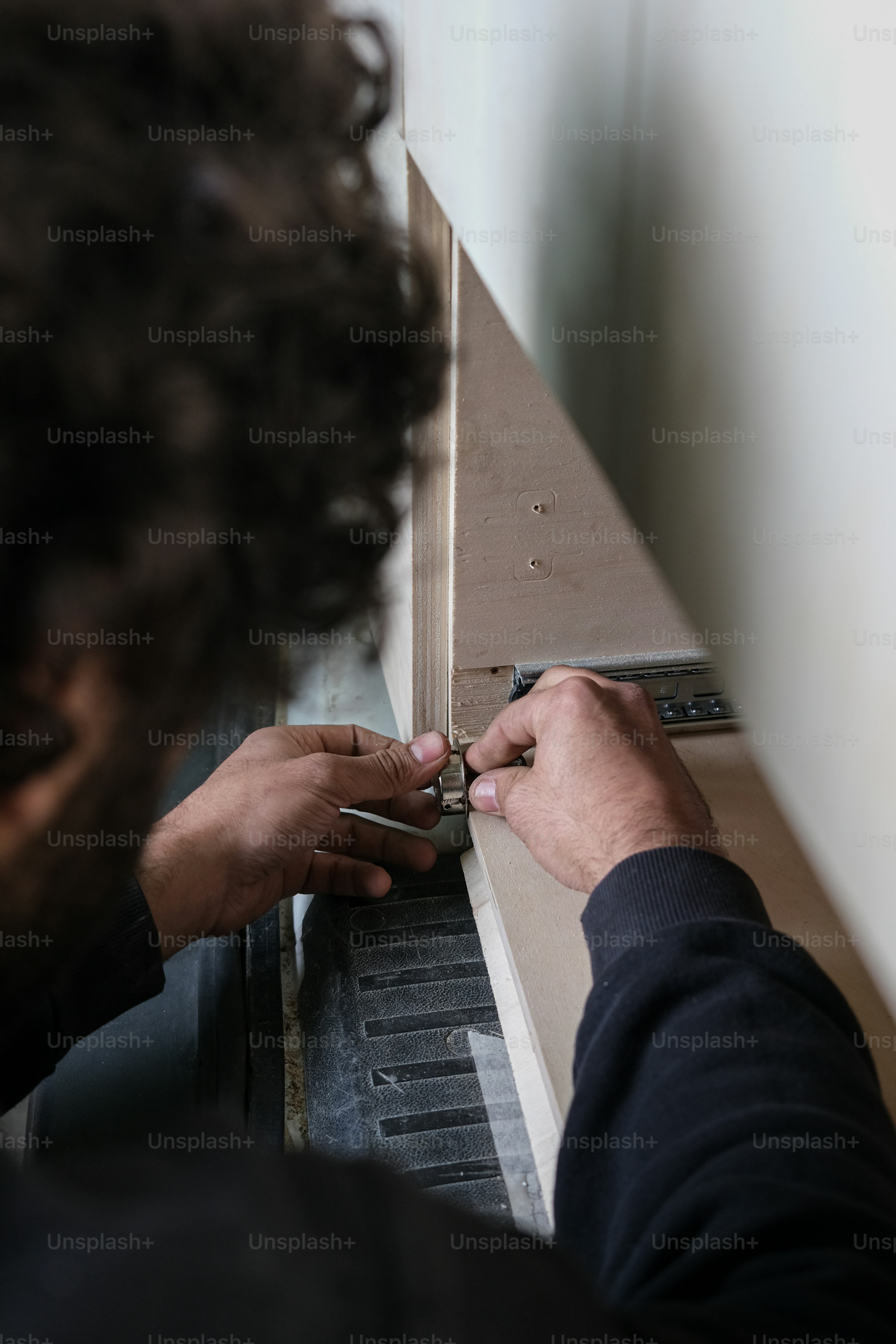 a man is opening a door with a pair of scissors