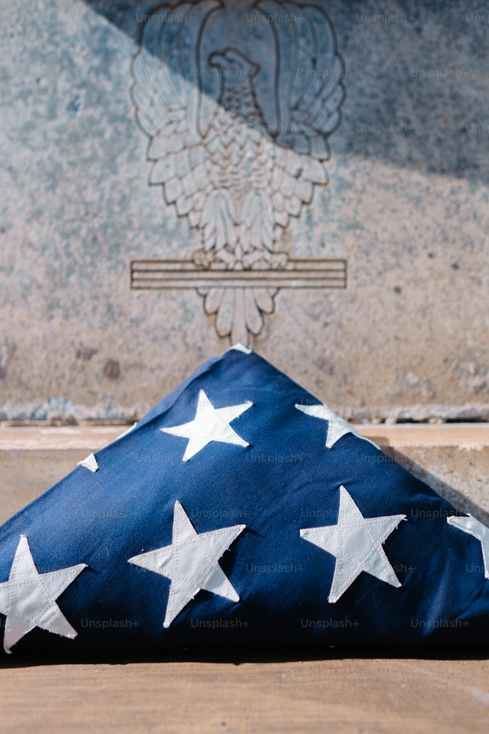 a flag laying on the ground in front of a monument