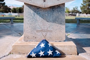 a flag laying on top of a stone monument