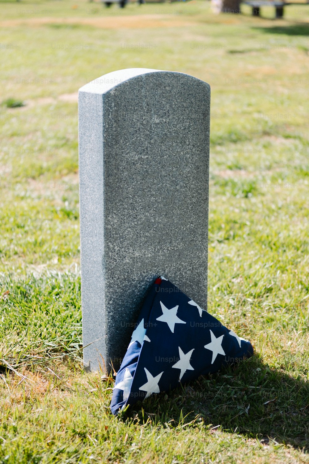 a flag laying on the ground next to a grave