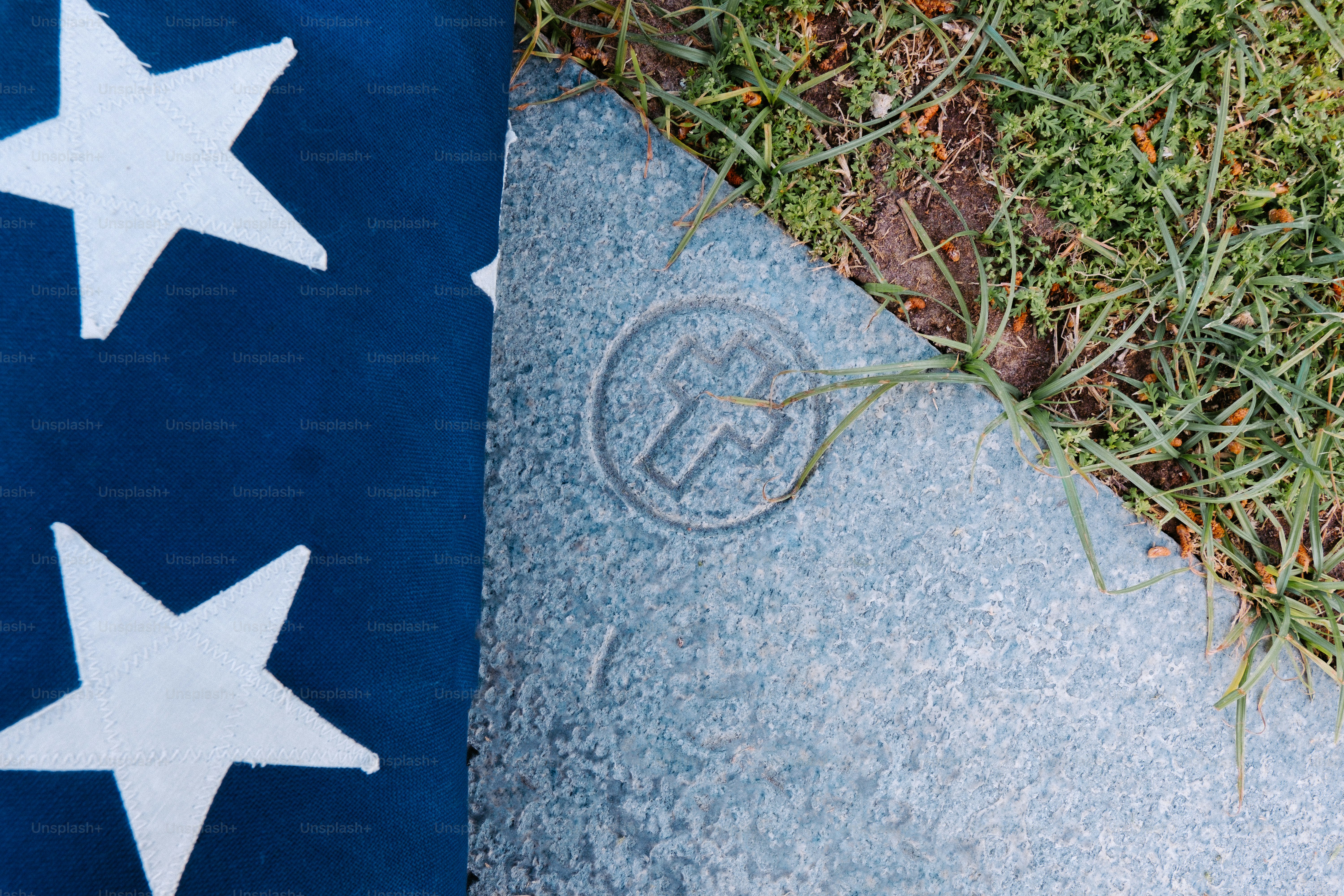 a blue and white flag laying on top of a sidewalk