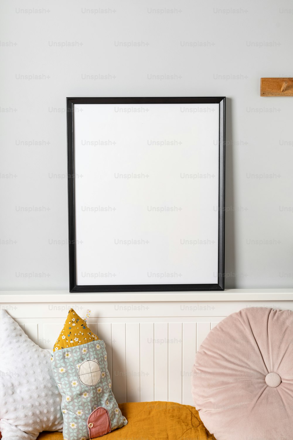a picture frame hanging on a wall above a bed