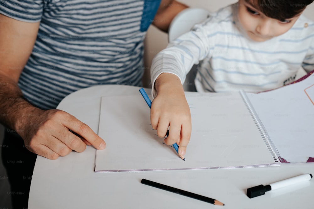 a man and a child are sitting at a table