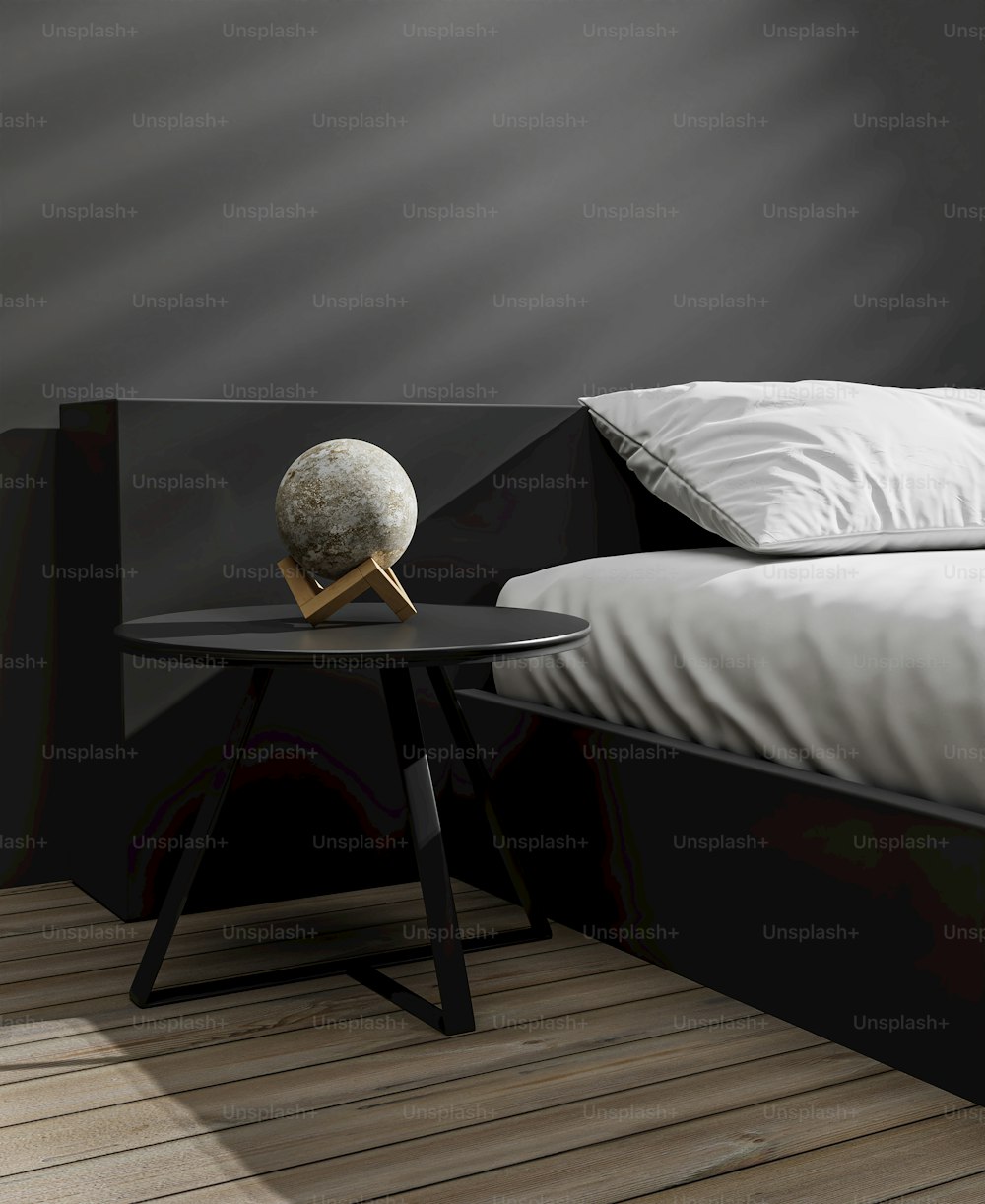 a bed with a black headboard and a white pillow