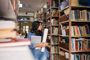 a woman holding a book in a library