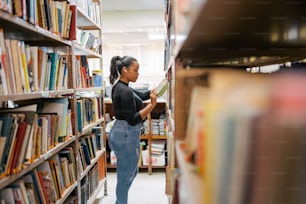 a woman reading a book in a library