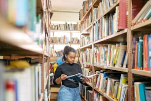 a woman reading a book in a library