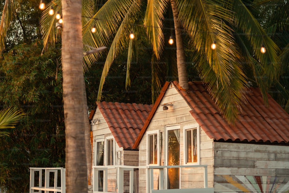 a small wooden house with a red tiled roof