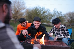 a group of people sitting around a fire pit