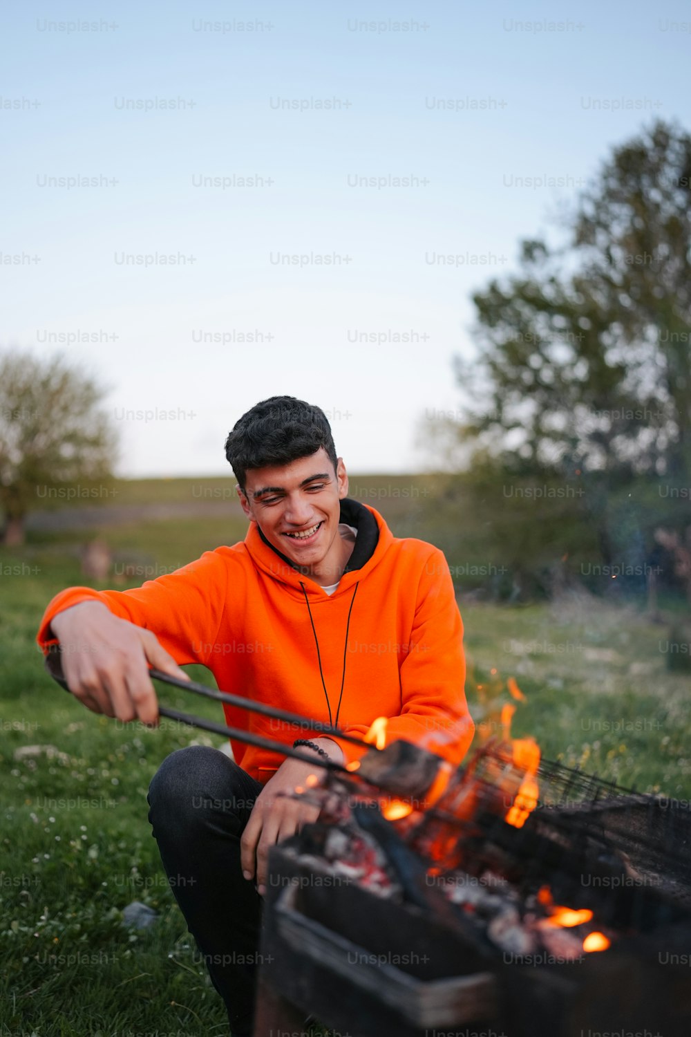 a man sitting in front of an open fire
