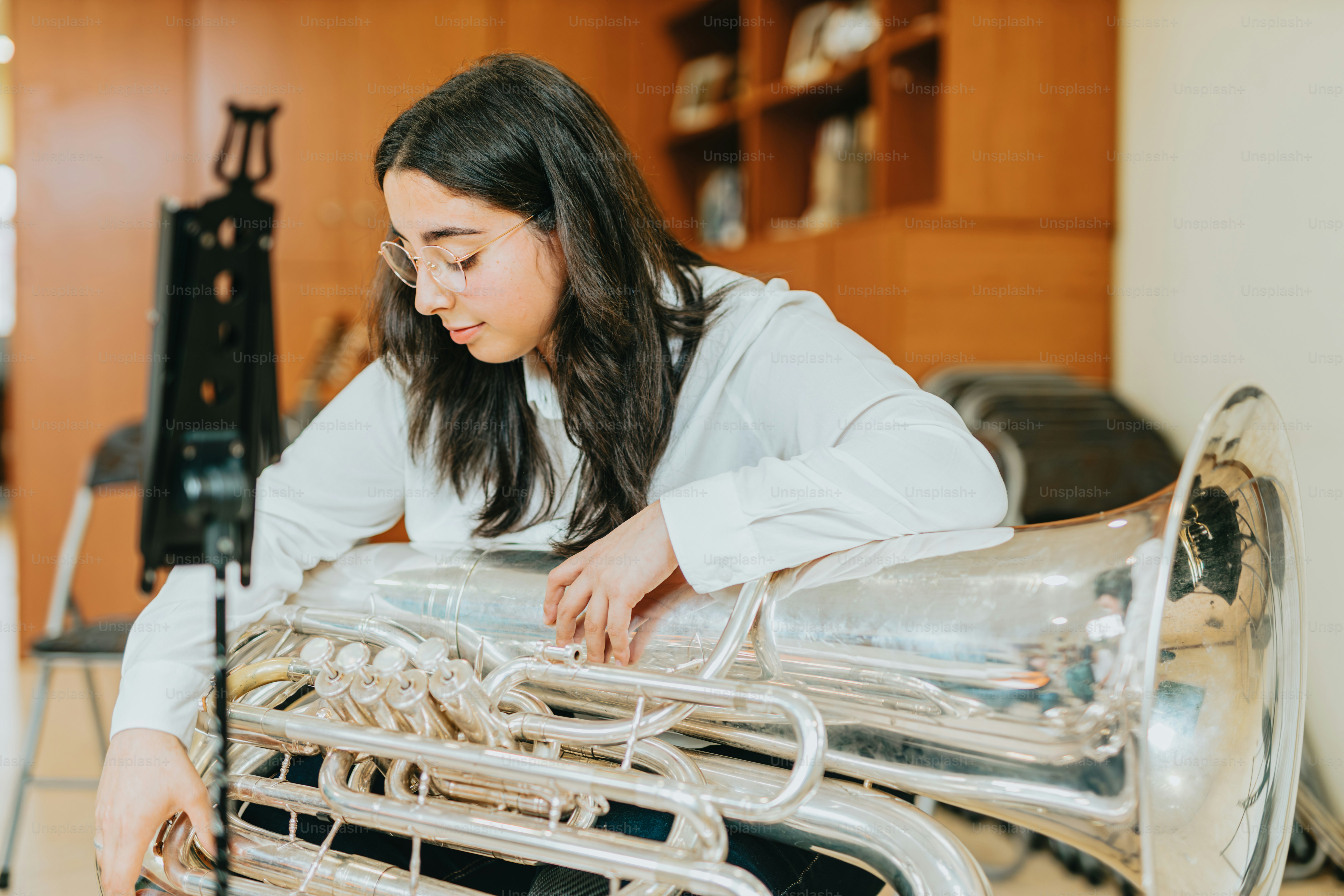 a woman in a white shirt is playing a musical instrument
