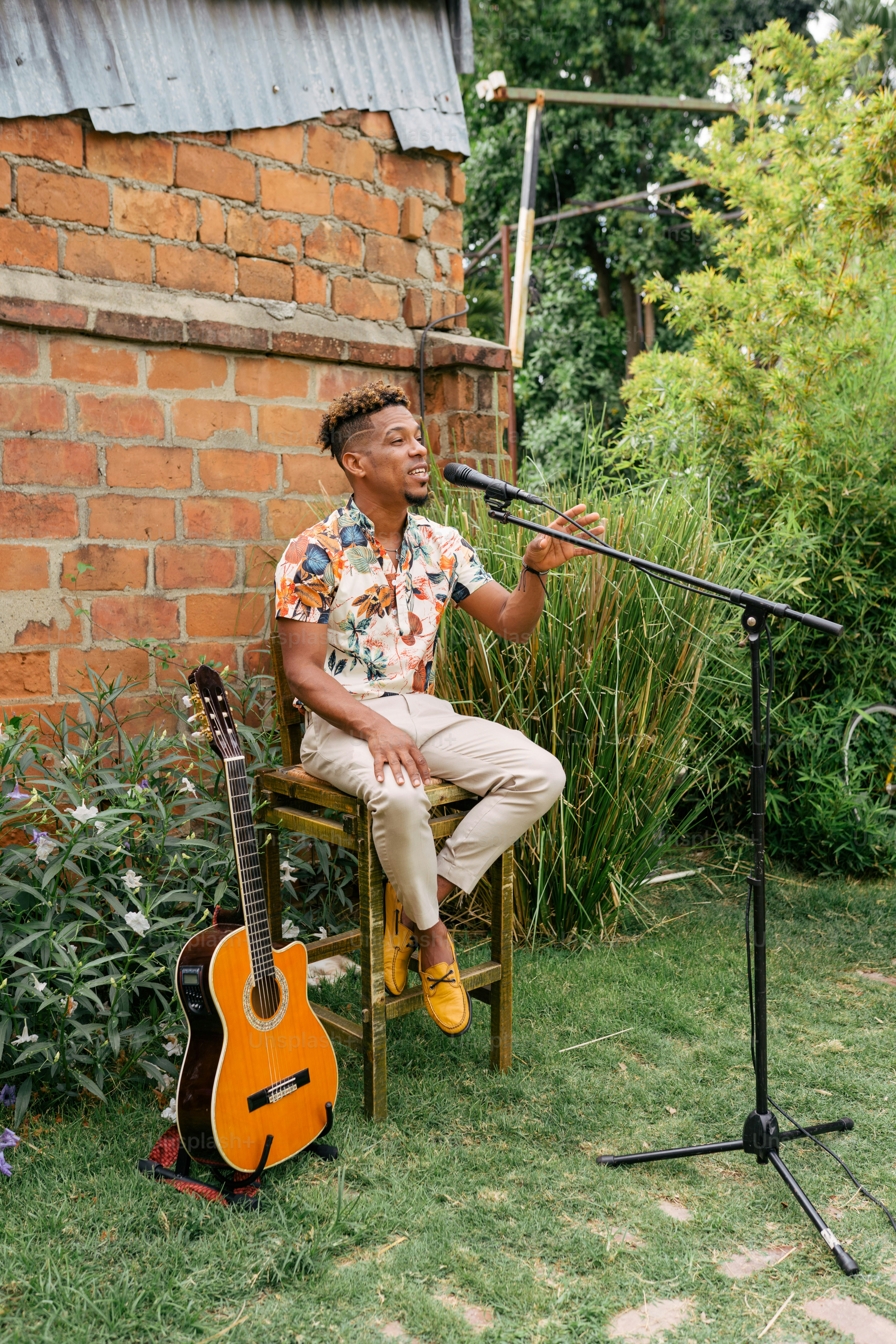 A man sitting in a chair with a guitar photo – Music Image on Unsplash