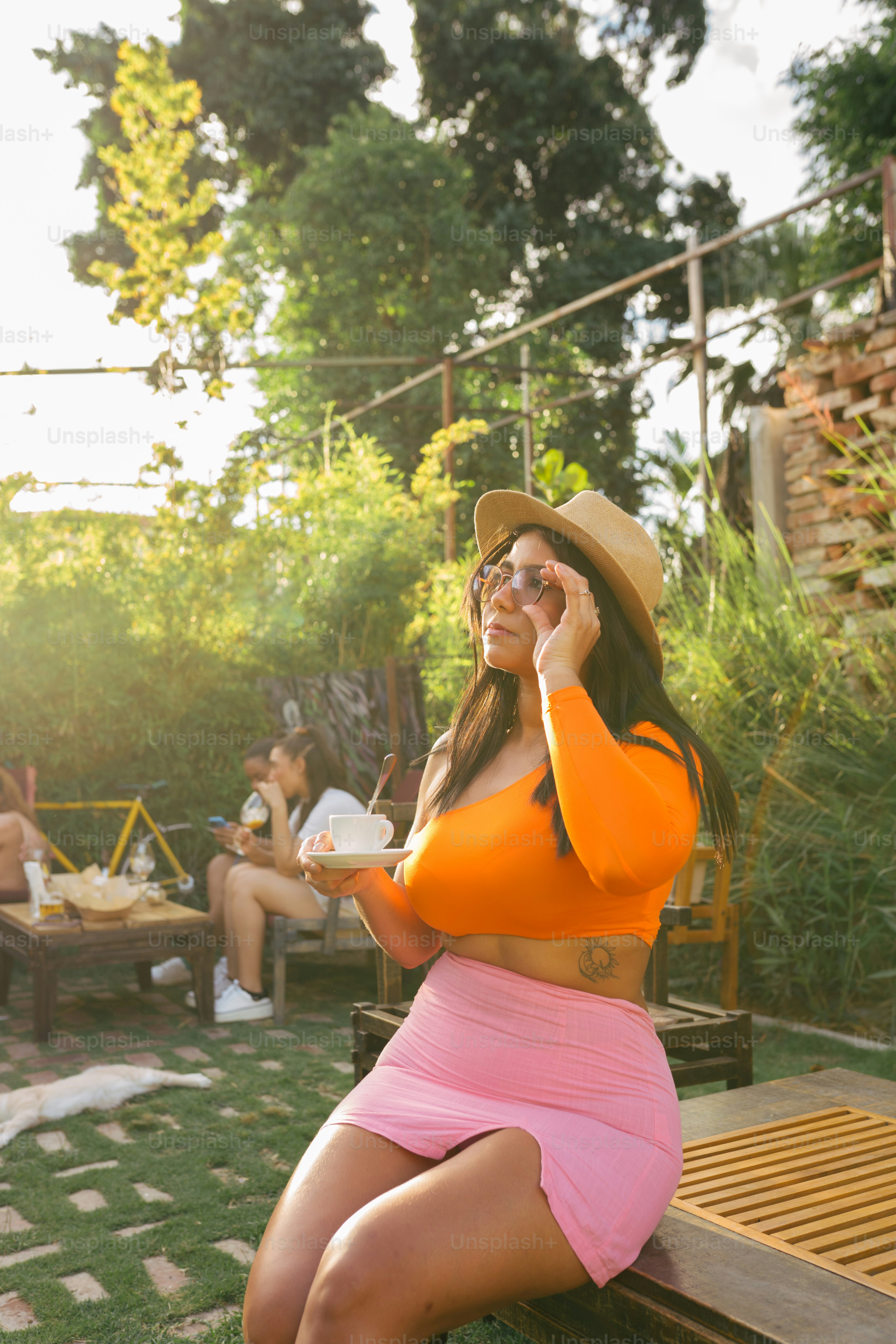 a woman sitting on a bench talking on a cell phone