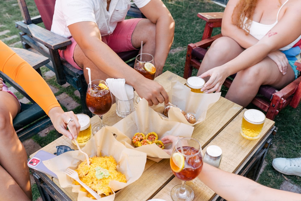 a group of people sitting around a table eating food