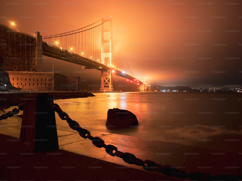 a foggy view of the golden gate bridge at night