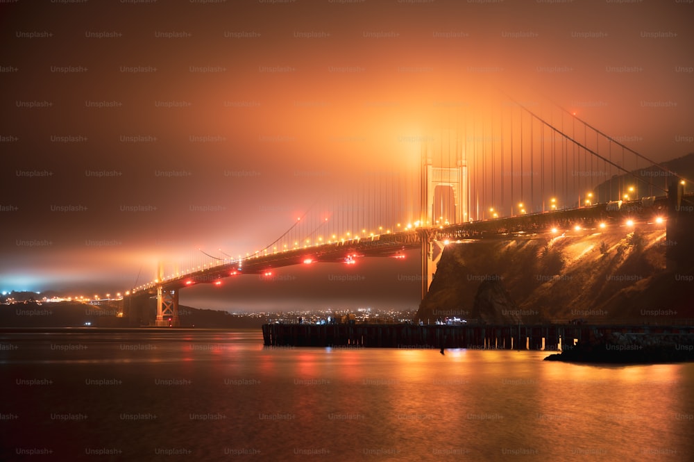 a foggy view of the golden gate bridge at night