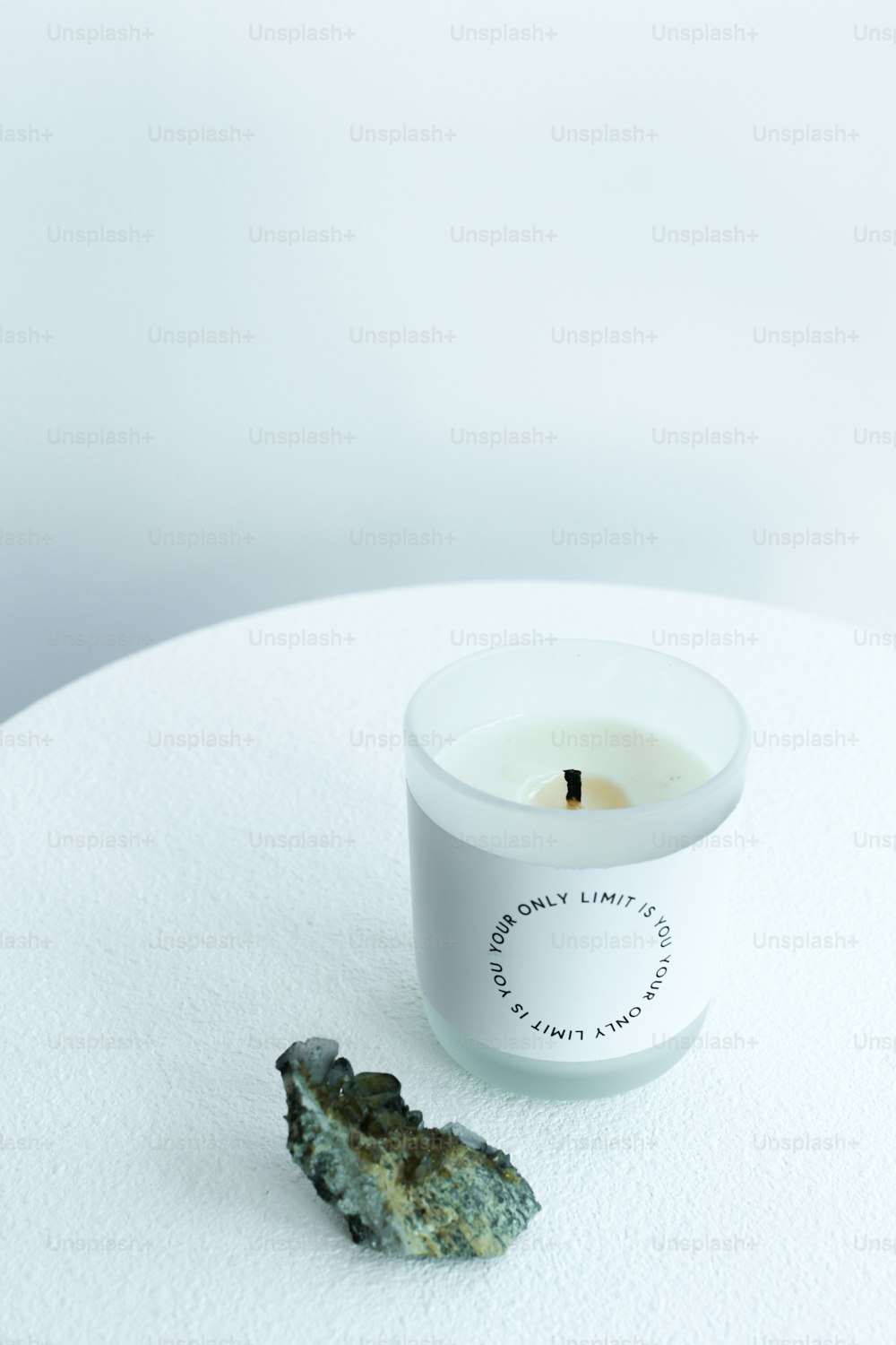 a candle sitting on top of a white table