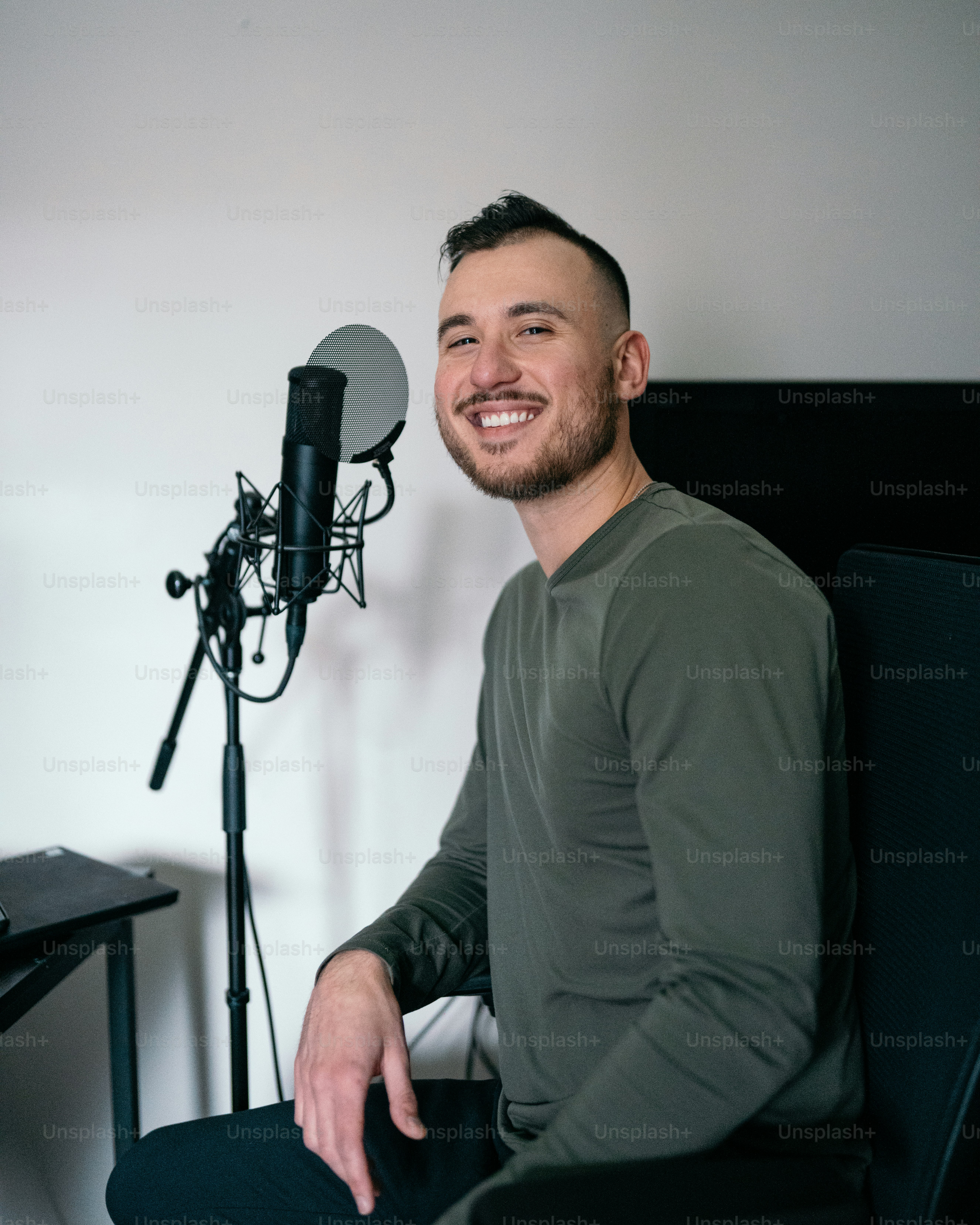 a man sitting in front of a microphone