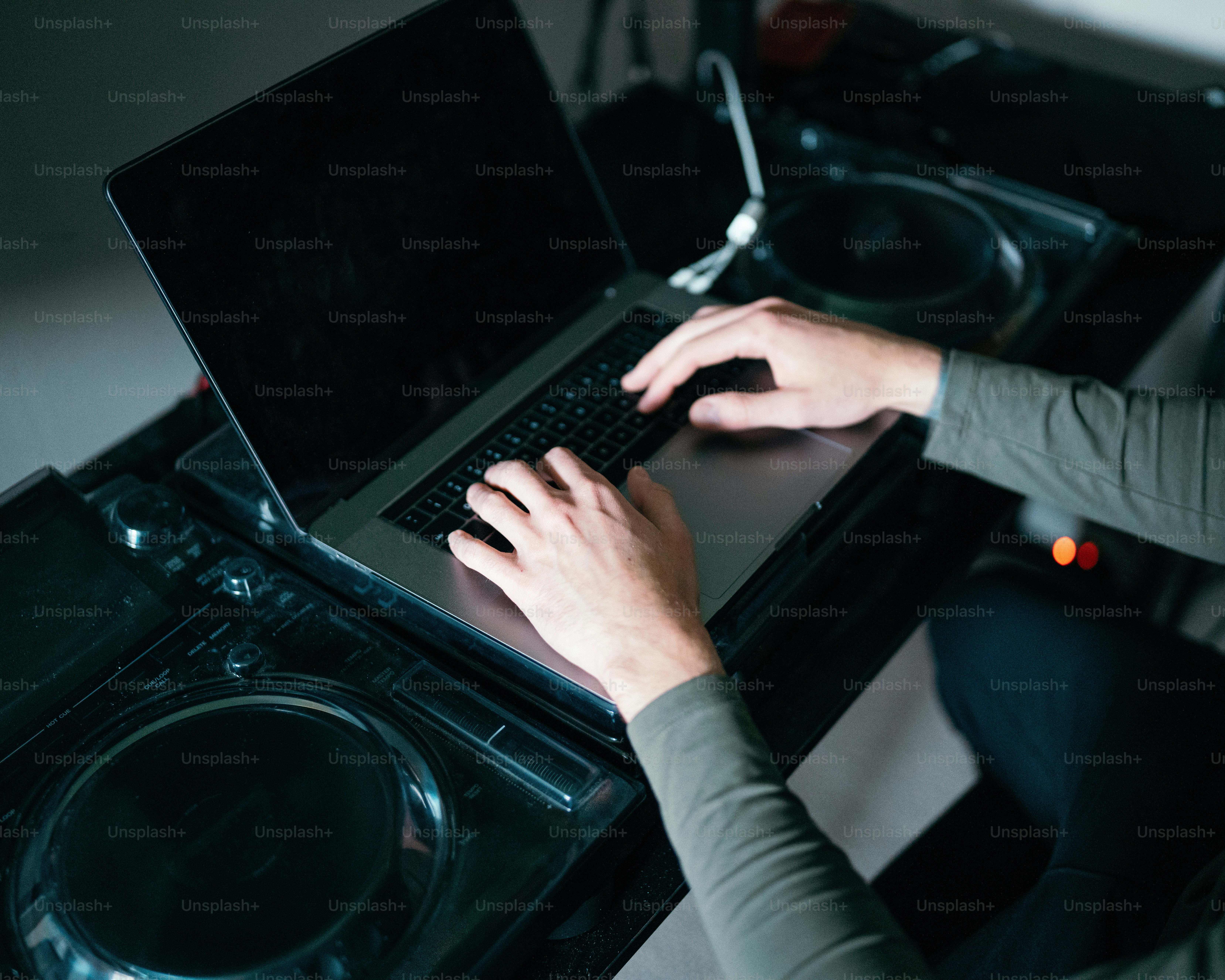 A person using a laptop on top of a dj's turntable photo – Technology ...