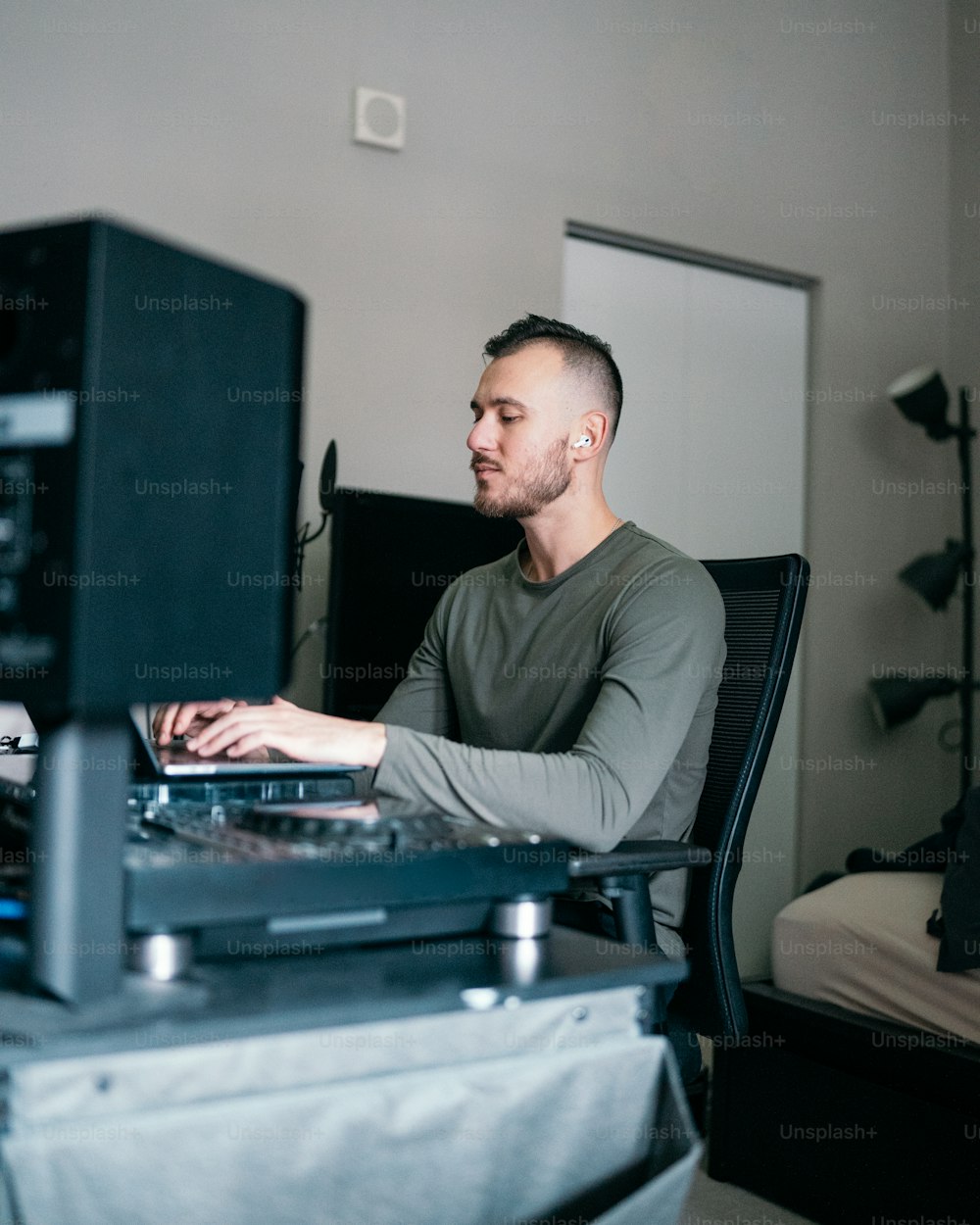 a man sitting in front of a laptop computer