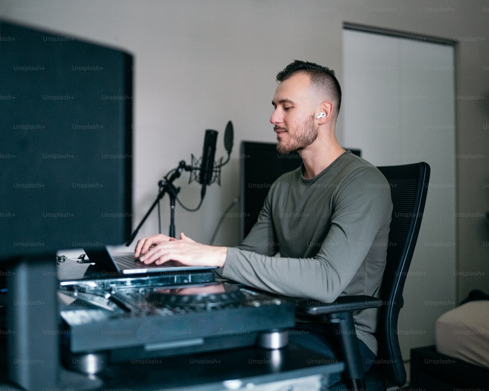 a man sitting in front of a laptop computer