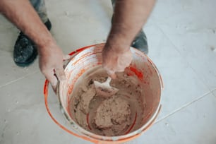 a person mixing something in a red bowl