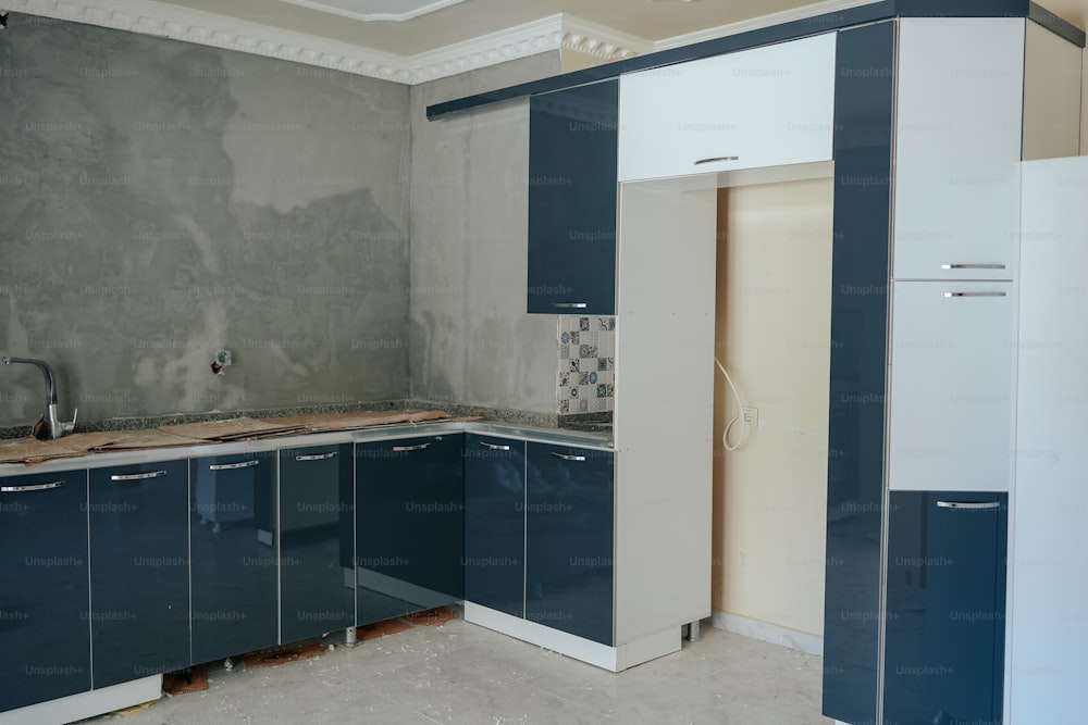 a kitchen that is being remodeled with blue cabinets
