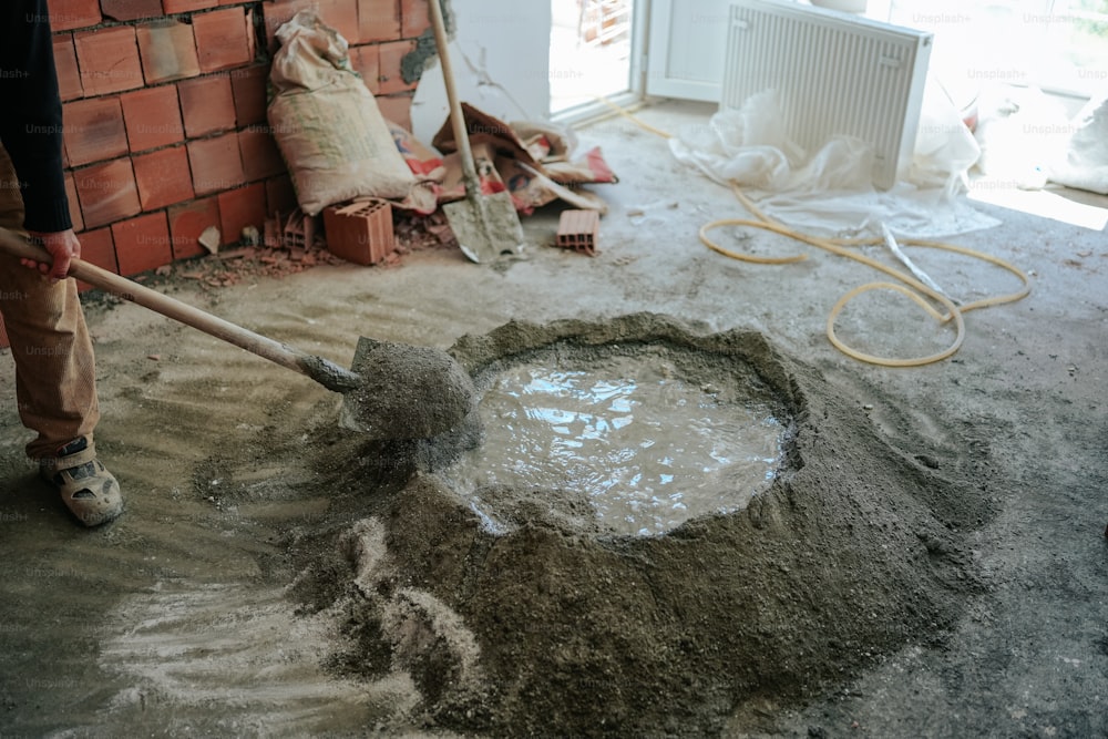 a man is shoveling sand into a hole