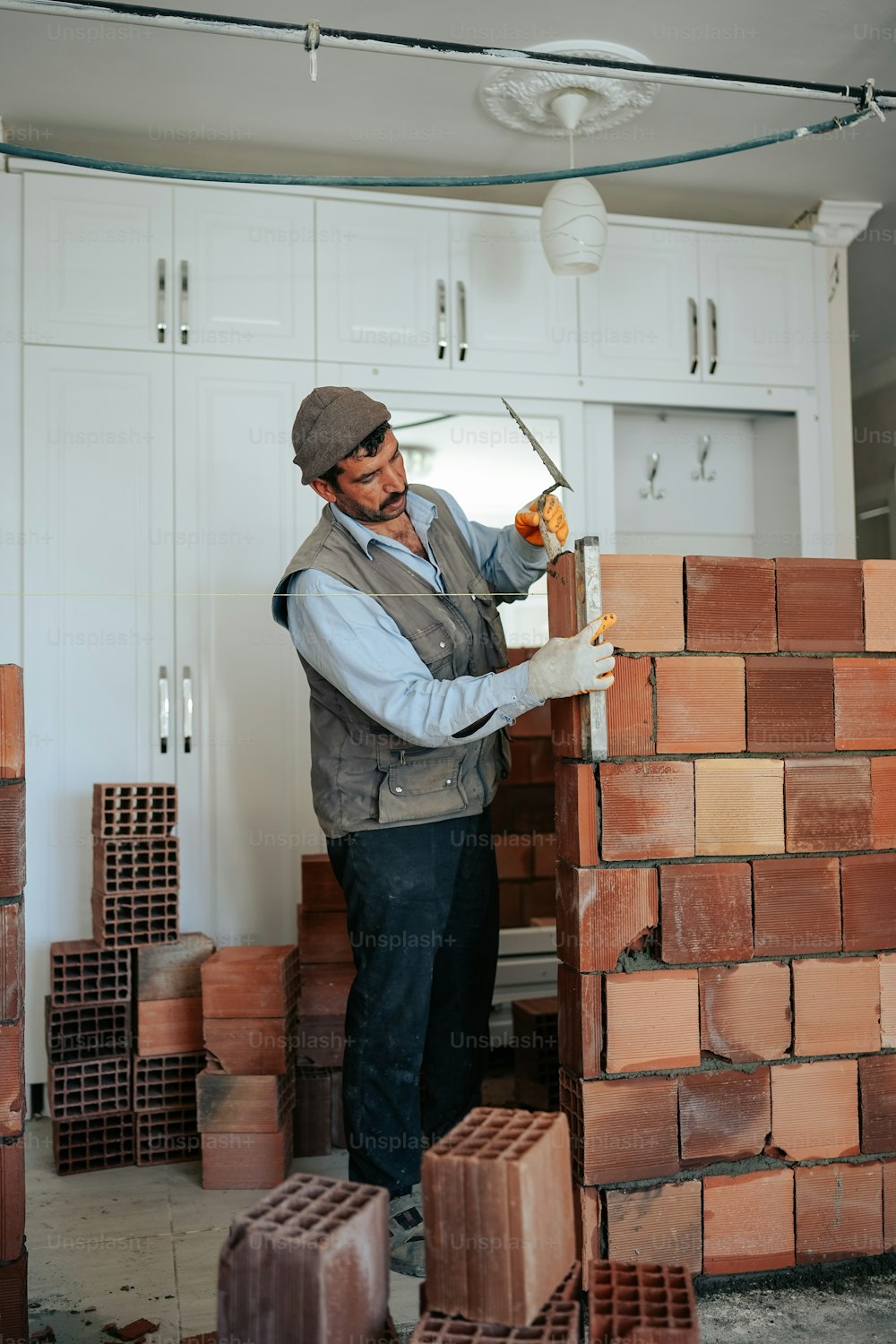 a man is working on a brick wall
